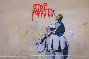 Ein Graffito des Straßenkünstlers TVBOY zeigt Papst Franziskus von hinten und ein Kind auf seinen Schultern in der Vicolo degli Osti in Rom am 23. März 2019. Der kleine Junge sprüht in roter Farbe die Aufschrift "Stop Abuse" an die Hauswand.